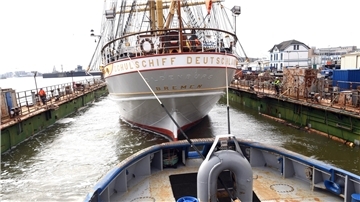 Segelschiff im Dock Am Haken: Die Schlepper stellen eine Leinenverbindung mit der „Schulschiff Deutschland“ im Dock her.