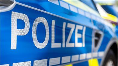 An der Tür eines Streifenwagens steht der Schriftzug „Polizei“.