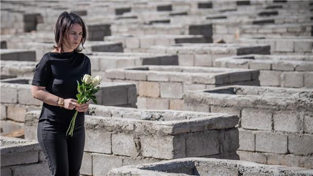Baerbock verspricht Jesiden nach Völkermord Aufbauhilfe Annalena Baerbock legt Blumen am Friedhof von Kocho nieder.