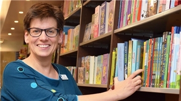 Frau am Bücherregal