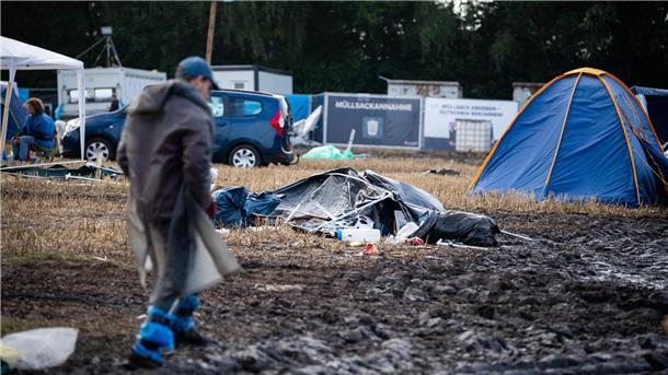 Müll, Matsch und Stau: So läuft die ABREISE beim Deichbrand-Festival (Fotos) Auf den Campingplätzen liegen Zelte, Müllsäcke und Möbel.