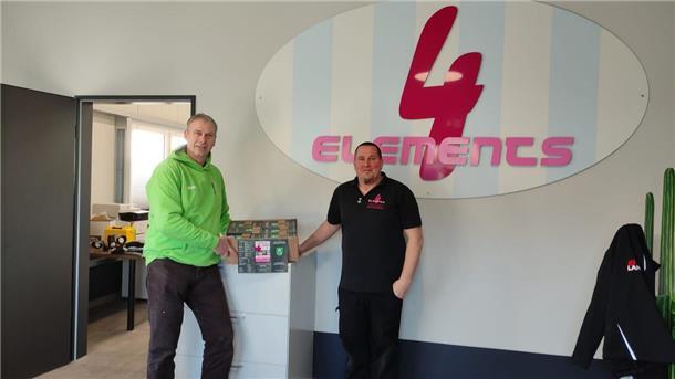 Bernd Sievert (links) mit dem Chef der Firma 4Elements, Bastian Pommert, und dem neuen Flyer.