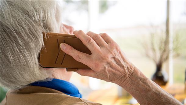 Eine Seniorin telefoniert mit einem Smartphone
