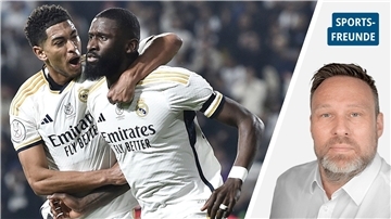 Zwei Fußballer in weißem Shirt feiern ein Tor.  Es sind Antonio Rüdiger (rechts) von Real Madrid und Jude Bellingham.
