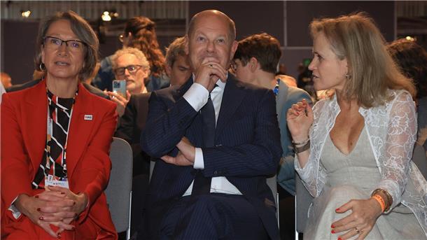 Bundeskanzler Olaf Scholz (SPD, M), sitzt bei der Eröffnung der 25. Welt-Aids-Konferenz zwischen Birgit Poniatowski (l), Geschäftsführerin der International AIDS Society (IAS) und Sharon Lewin (r), Präsidentin der International AIDS Society.