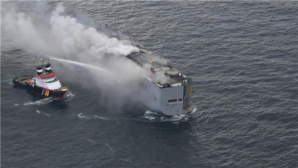Küstenwache: Brand auf Autofrachter kleiner geworden Der brennende Frachter „Fremantle Highway“ in der Nordsee. Links im Bild ist der deutsche Notschlepper „Nordic“ zu sehen, der das Feuer auf dem Frachter bekämpft.