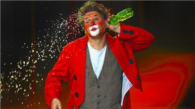 Ein Clown spuckt Wasser
