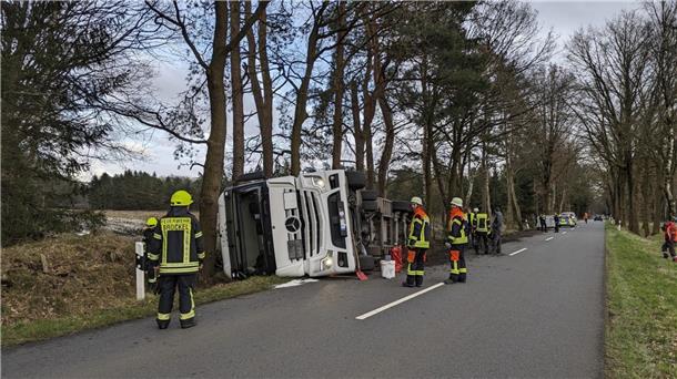 Der umgekippte Tanklastzug im Trochel bei Brockel. Einsatzkräfte von Polizei und Feuerwehr sichern die Unfallstelle ab.