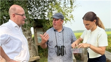 Detlef Ertel, Mitarbeiter des Wiesenvogelprojektes, erläutert Dr. Marco Mohrmann die Bedeutung des Wiesenvogelschutzes. Vanessa Zobel betrachtet die mitgebrachten Brachvogel-Eischalen. 