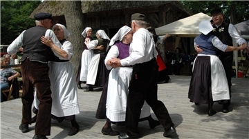 Paare tanzen in norddeutschen Trachten auf der Bühne beim Heeslinger Heimattag.