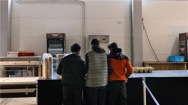 Mehr Geld für Alleinstehende in Flüchtlingsheimen Drei junge Männer im Kantinenbereich einer Notunterkunft in Offenburg.