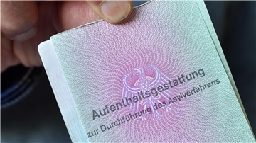Ein aus Syrien geflüchteter Mann mit seiner Aufenthaltsgestattung.