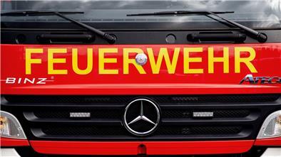 Ein Einsatzfahrzeug der Feuerwehr steht  auf einem Parkplatz.