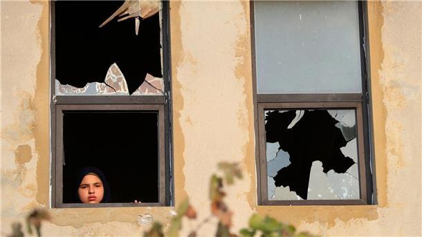 Vergeltung mit Raketen: Hisbollah feuert auf Israel Ein libanesisches Mädchen blickt nach israelischem Beschuss auf ein Dorf im Südlibanon durch ein zerbrochenes Fenster.
