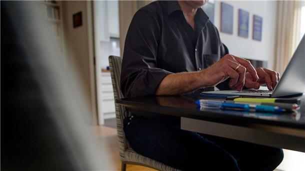 Ein Mann sitzt Zuhause am Computer.