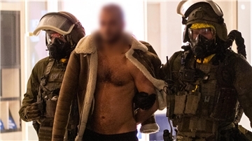 Ein Mann wird von Beamten des Spezialeinsatzkommandos (SEK) in Gewahrsam genommen.