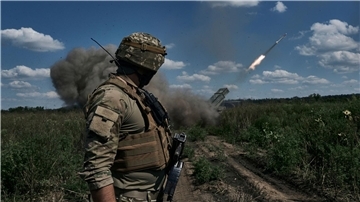 Ein ukrainischer Soldat beobachtet, wie ein Grad-Mehrfachraketenwerfersystem in der Nähe von Bachmut Raketen abfeuert.