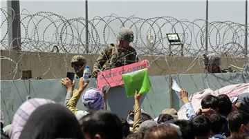 Ein US-Soldat hält wenige Tage nach der Machtübernahme der Taliban 2021 ein Schild, mit der Aufschrift „Gate closed“ auf dem internationalen Flughafen von Kabul.