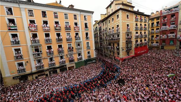 Zehntausende feiern in Spanien Start der blutigen Stierhatz Eine begeisterte Menschenmenge feiert die Eröffnung des Sanfermín-Festes.
