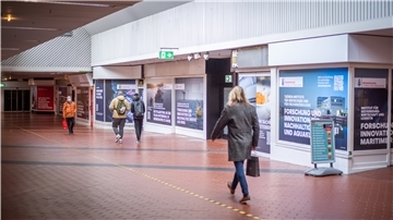 Mehrere Personen laufen durch die Passage.