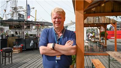 Ralf Meyer lehnt an einem Stand.
