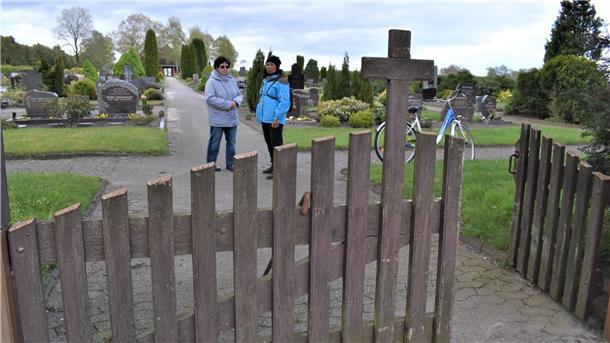 Rehe, nein danke: Warum Köhlener ohne Umzäunung ihres Friedhofs leben müssen Zwei Frauen auf einem Friedhof