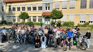 Das Foto zeigt mehrere Schüler mit ihren Fahrrädern auf dem Schulhof des Nordenhamer Gymnasiums. Anlass ist der europäische Fahrradtag.