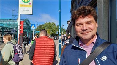 Bahn-Sperrung zwischen Bremerhaven und Bremen: So läuft es mit den Ersatzbussen Ein Mann an einer Haltestelle blickt in die Kamera und lächelt.