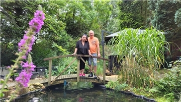 Janine und Volker Brockmann alias "Janine & Schatzi" in ihrem Garten. Das Ehepaar hat sich via TikTok eine riesige Fangemeinde aufgebaut.