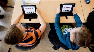 Zwei Schüler lernen mit iPads im Unterricht.