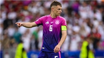 Joshua Kimmich zeigt auf dem Fußballplatz die Richtung an. 