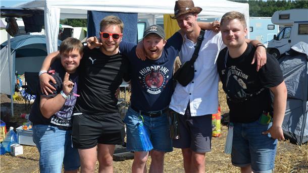 Ein Gruppe junger Männer schaut lächelnd in die Kamera.