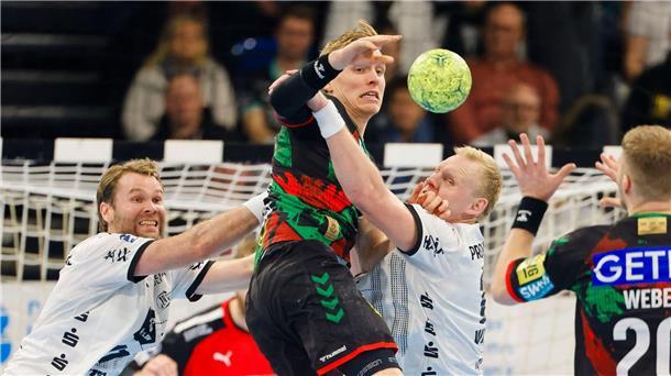 THW Kiel gewinnt 31:25 gegen den SC Magdeburg Magdeburgs Gisli Kristjansson wird von der Kieler Abwehr gestoppt.