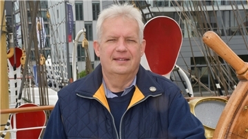Mann zwischen Takelage eines Schiffs