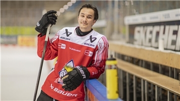 Ein Eishockey-Spieler hält einen Schläger in der Hand und lehnt sich lässig an der Bande an. Neuzugang Akito Hirose von den Fischtown Pinguins aus Bremerhaven.