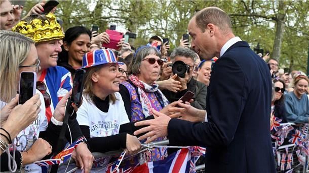 Prinz William (r) begrüßt Gratulanten vor dem Buckingham Palace.