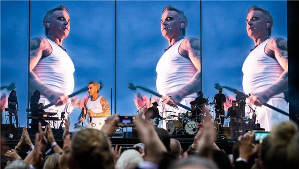 Mit neuen Zähnen und altem Po: Robbie Williams begeistert Hamburg Robbie Williams zeigte sich auf der Trabrennbahn in Hamburg beim ersten von zwei Konzerten fit wie schon lange nicht mehr.