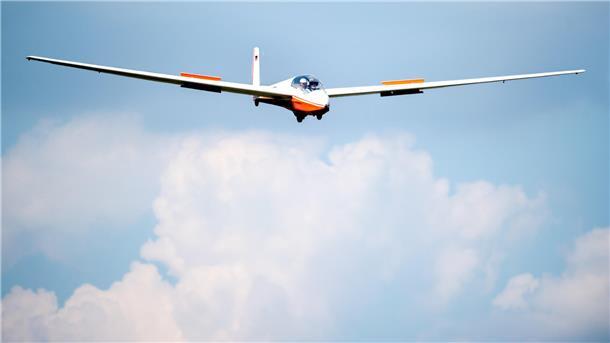 Das Foto zeigt ein Segelflugzeug in der Luft. 