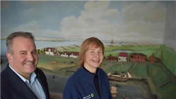Sie freuen sich über die finanzielle Stärkung des Nationalparkhauses und Museums in Fedderwardersiel: Dr. Anika Seyfferth (Einrichtungsleitung) und Tourismus-Geschäftsführer Robert Kowitz - hier vor dem Diorama des historischen Handelshafens Fedderwardersiel.