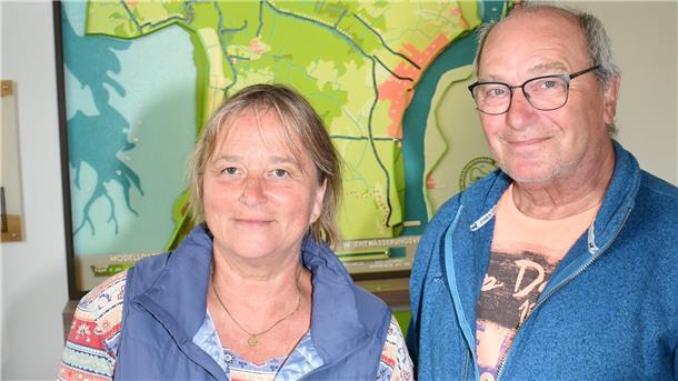 Eine Frau und ein Mann stehen in einem Museum vor einem Modell, das Butjadingen zeigt.