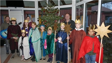 Sternsinger waren zu Gast im Loxstedter Rathaus. Begleitet wurden sie unter anderem von Andreas Rotterdam (Gitarre) und Franziska Wallott (hinten links). Begrüßung und Spendenübergabe übernahm Loxstedts Erster Gemeinderat Holger Rasch (hinten rechts).