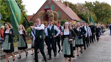 Stolz führt die Landjugend den Umzug an und trägt die Erntekrone durch das ganze Dorf.