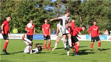 Viele Männer in weißen und roten Trikots auf einem Fußballfeld.