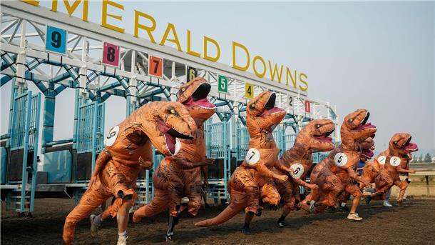 T-Rex-Kostümrennen mit über 200 Läufern Teilnehmer verlassen die Startbox für das Meisterschaftsrennen bei den T-Rex World Championship Races in Emerald Downs.