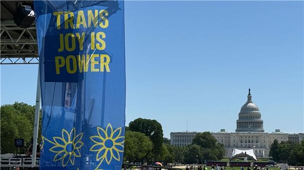 „Trans joy is power“ steht auf einem Banner an einer Bühne vor dem Kapitol am ersten Tag der Worldpride. 