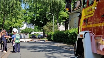 Trümmer liegen auf der Straße nach dem Absturz eines Segelflugzeugs im Stadtgebiet von Wetzlar.