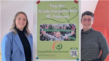 (Von links) Verena Hilker und Kirsten Malle präsentieren ein Plakat mit der Aufschrift "Tag der Kinderhospizarbeit".