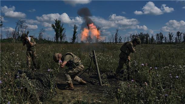 Ukrainische Soldaten feuern mit einem Mörser auf russische Stellungen an der Frontlinie bei Bachmut.