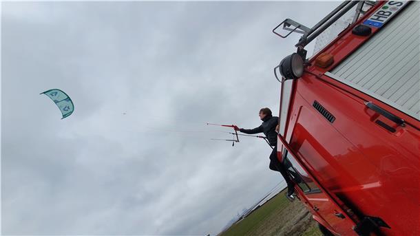 Wenn das Hochwasser am Wremer Strand mal auf sich warten lässt, klettert Ansgar Pahl für eine Trockenübung auch mal auf sein ausgedientes Feuerwehrfahrzeug, von dem aus er die Kiteschule in diesem Jahr betreibt.