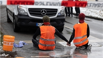 Zwei Klimaaktivisten während einer Protestaktion der Gruppe „Letzte Generation“ in München.